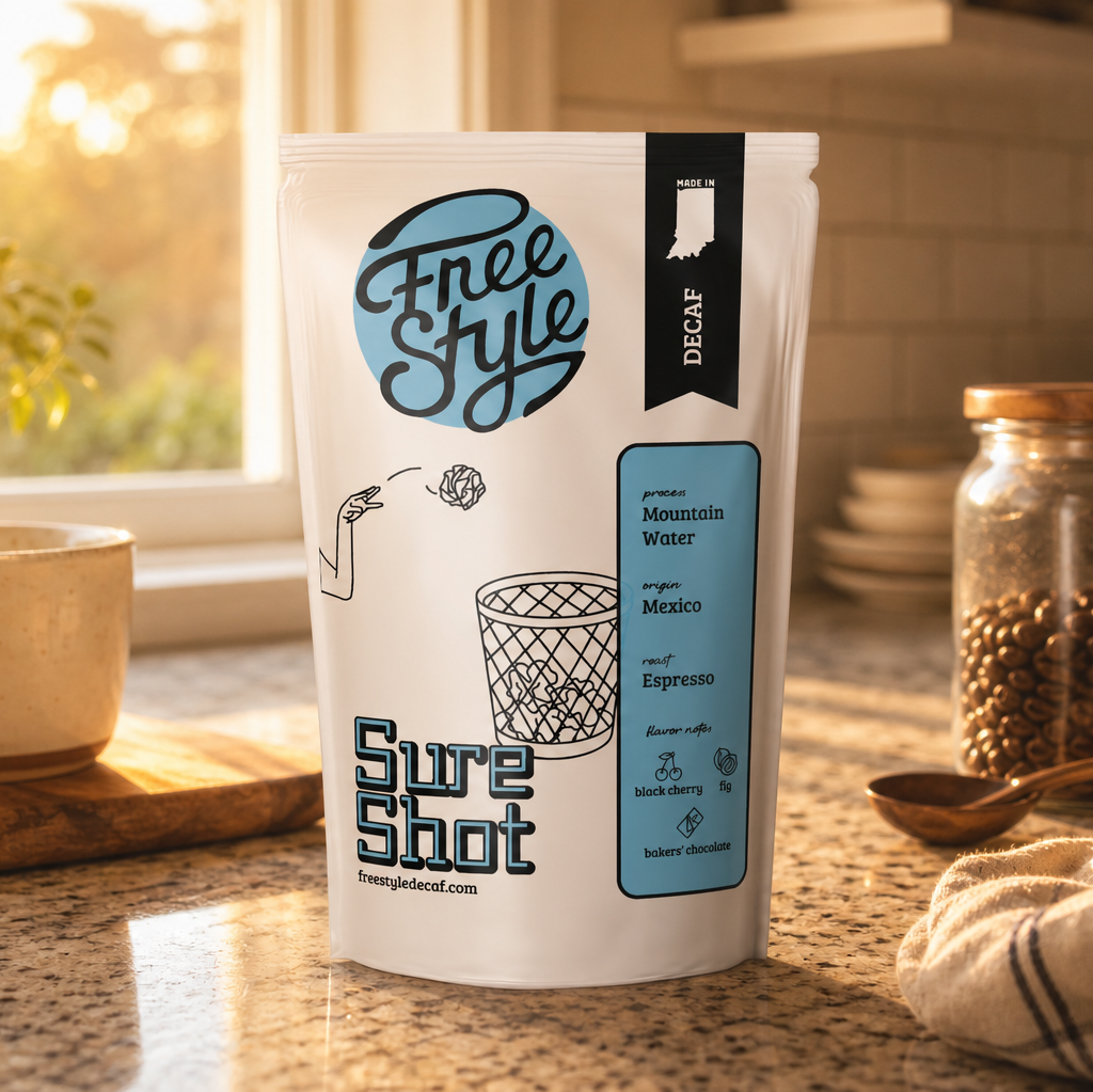 Close-up of a bag of Freestyle Decaf Coffee's Founder's Favorites with a fresh brew in a mug, highlighting rich coffee beans and aroma.